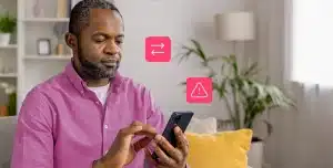 Homem utiliza seu smartphone, em fotomontagem com ícones e que ilustra artigo sobre botão de contestação do Pix