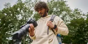 Fotógrafo observa o display de sua câmera fotográfica, em imagem que ilustra artigo sobre trabalho freelancer